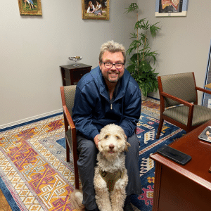 man with dog in office