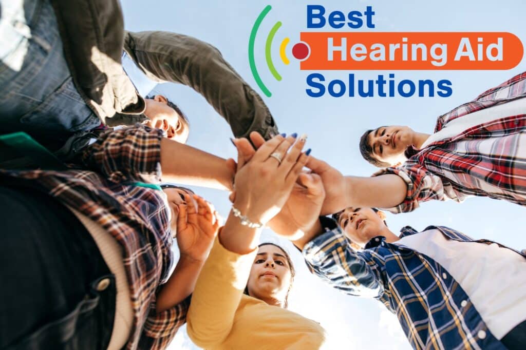 A group of teens with their hands together