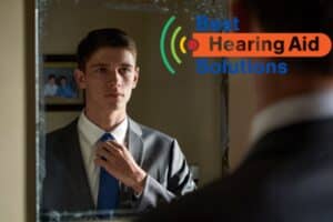 young man adjusting his tie in the mirror